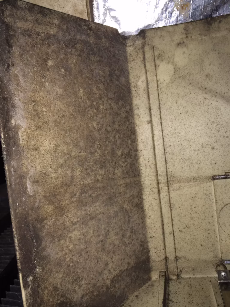 Interior photo of a furnace plenum is covered with mold growth in this Lake City, TN home.